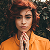 Portrait d'une femme aux cheveux roux courts en veste orange